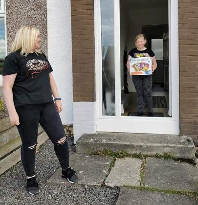 Volunteer delivery to young girl at the doorstep